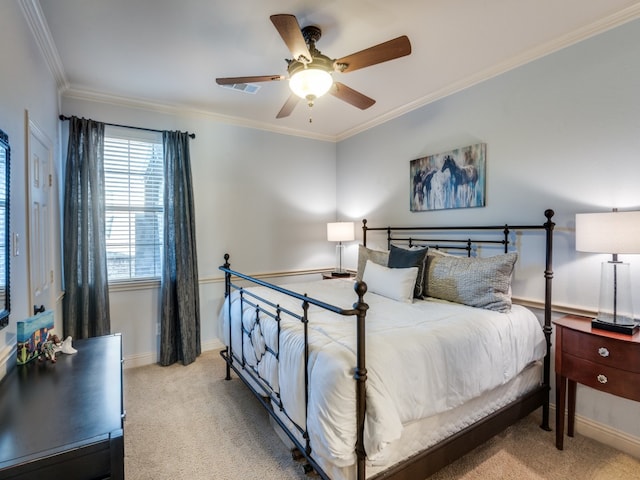 carpeted bedroom featuring crown molding and ceiling fan