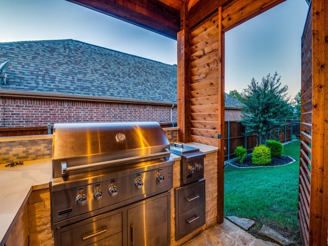 view of patio with an outdoor kitchen and area for grilling