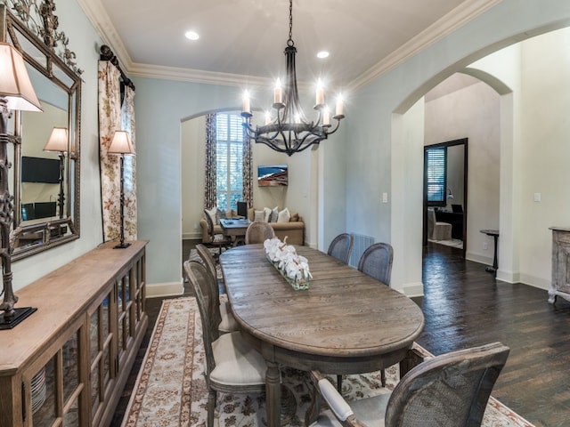 dining area featuring crown molding, dark hardwood / wood-style flooring, and a chandelier