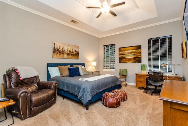 bedroom featuring ceiling fan, a raised ceiling, light carpet, and ornamental molding