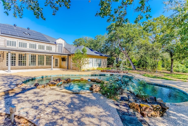 view of swimming pool with a patio and a hot tub