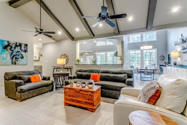 living room with ceiling fan, beam ceiling, and high vaulted ceiling