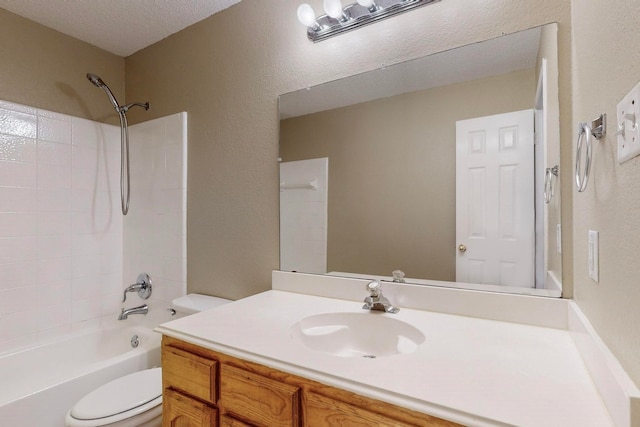 full bathroom featuring a textured ceiling,  shower combination, vanity, and toilet