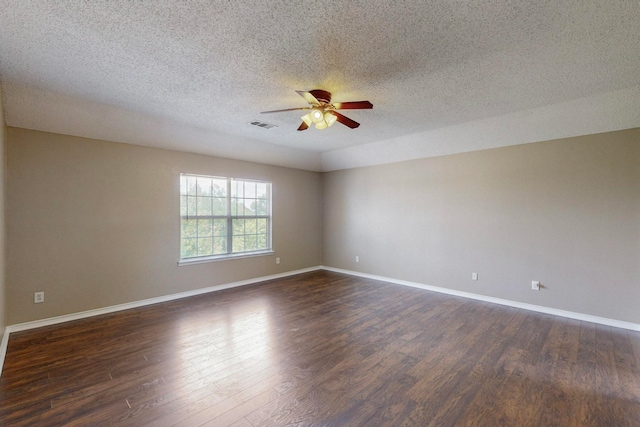 spare room with ceiling fan, a textured ceiling, and dark hardwood / wood-style flooring