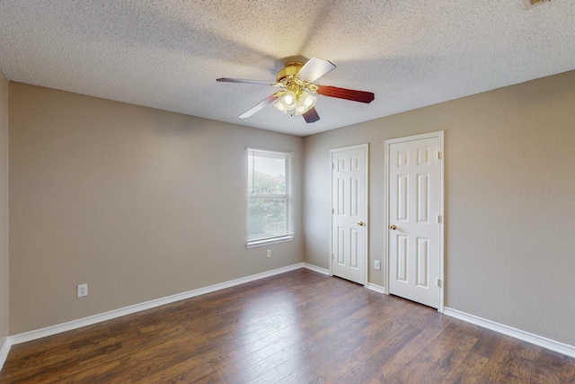 unfurnished bedroom featuring a textured ceiling, dark wood-type flooring, and ceiling fan