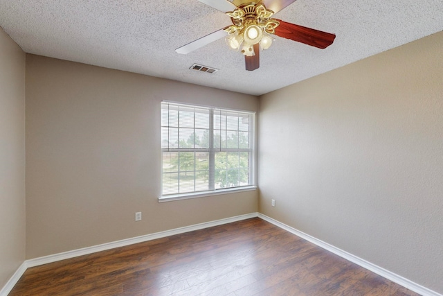 unfurnished room featuring ceiling fan, a textured ceiling, and dark wood-type flooring