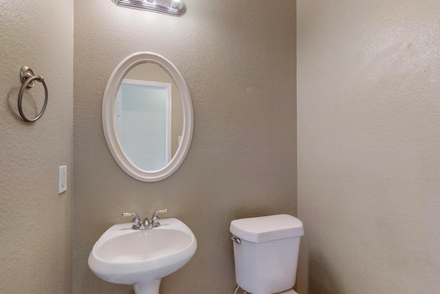 bathroom with toilet and sink