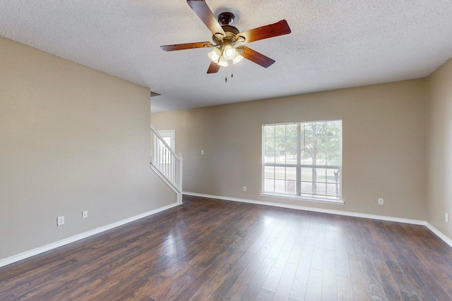 empty room featuring ceiling fan, a textured ceiling, and dark hardwood / wood-style floors