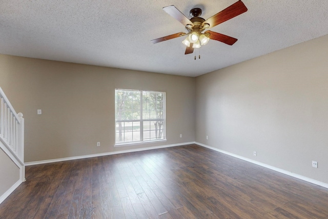 empty room featuring ceiling fan, a textured ceiling, and dark hardwood / wood-style flooring