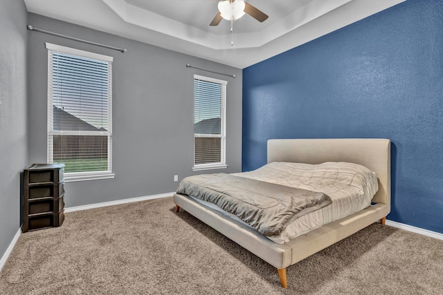 bedroom with carpet flooring, ceiling fan, and multiple windows