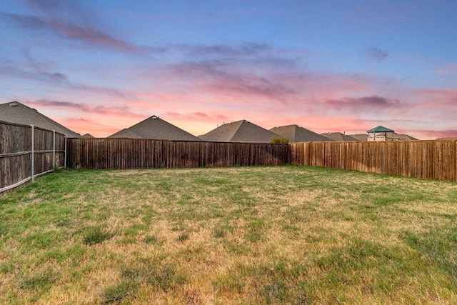 view of yard at dusk