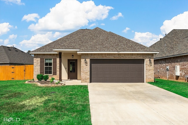 view of front facade with a garage and a front lawn