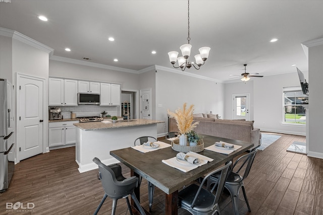 dining room with ceiling fan with notable chandelier, dark hardwood / wood-style floors, and crown molding