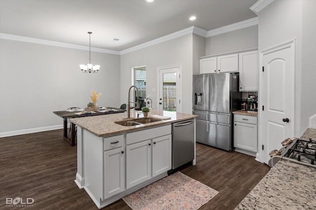 kitchen with light stone counters, dark hardwood / wood-style floors, sink, white cabinetry, and stainless steel appliances