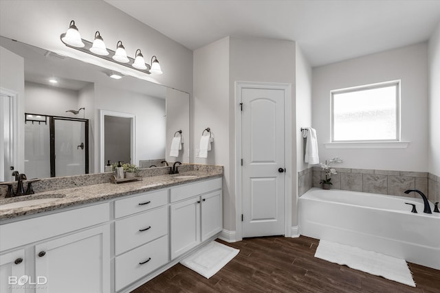 bathroom featuring wood-type flooring, vanity, and separate shower and tub