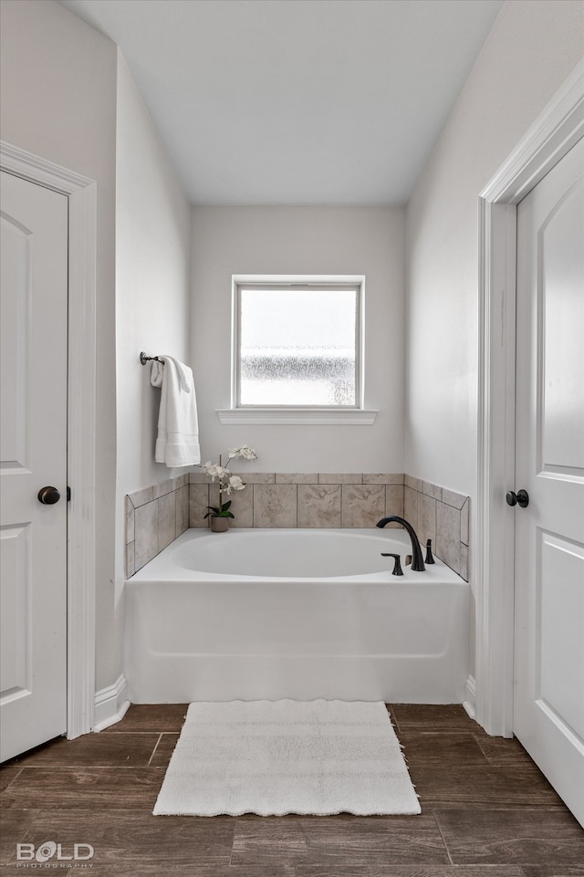 bathroom featuring a bathtub and hardwood / wood-style floors