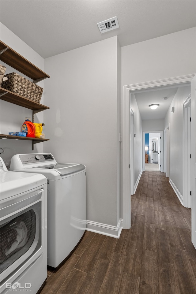 laundry area featuring dark wood-type flooring and washer and dryer