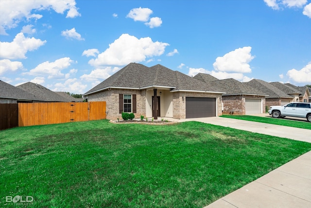 view of front of property featuring a front yard and a garage