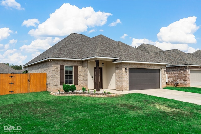 view of front of property with a garage and a front lawn