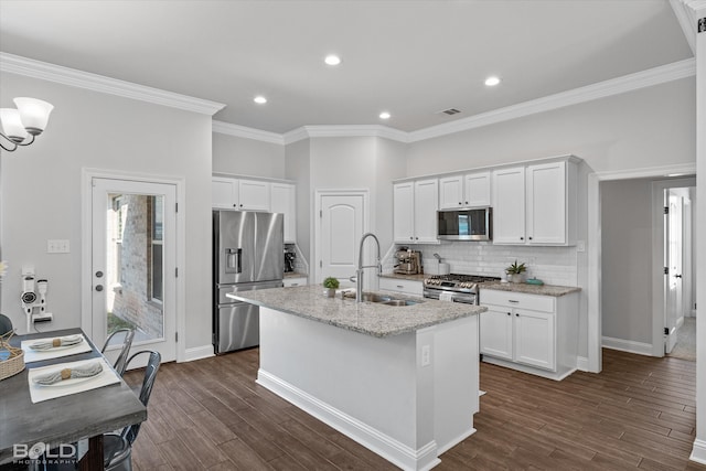 kitchen with stainless steel appliances, white cabinets, a center island with sink, and dark hardwood / wood-style flooring