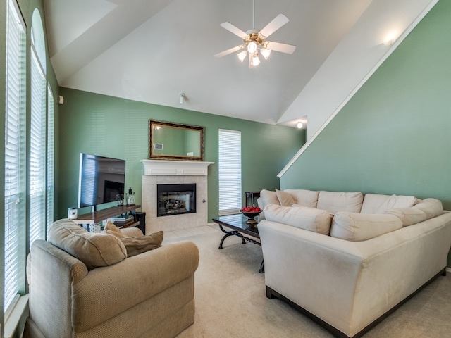 living room with ceiling fan, a fireplace, light colored carpet, and lofted ceiling