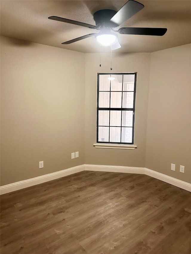 unfurnished room with ceiling fan and dark hardwood / wood-style flooring