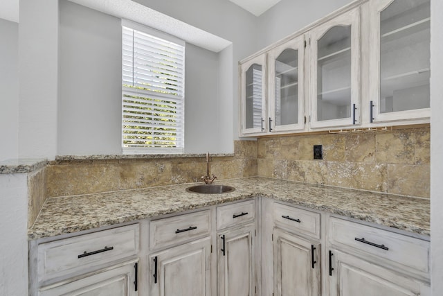 kitchen with light stone countertops and sink