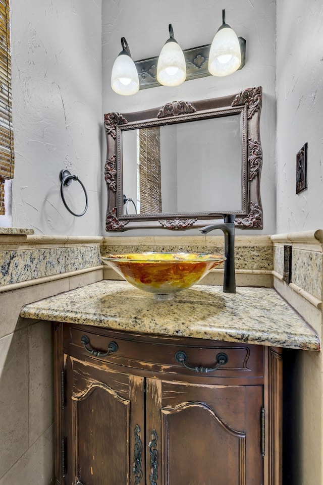 bathroom featuring tile walls and vanity