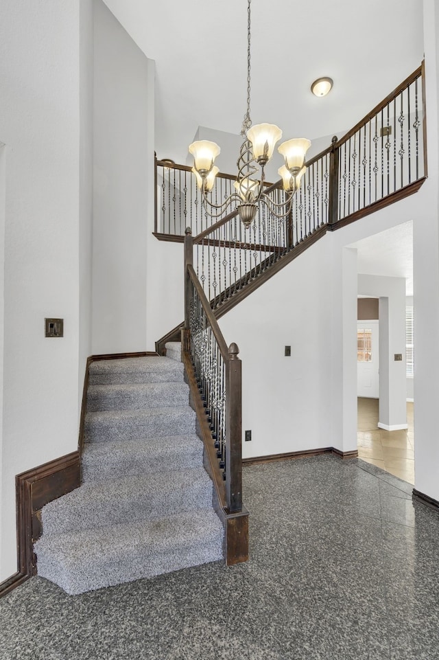 stairs featuring an inviting chandelier