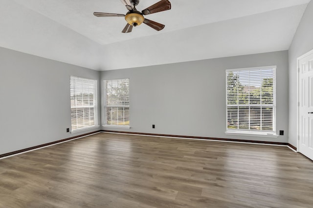 empty room featuring ceiling fan, lofted ceiling, and hardwood / wood-style floors