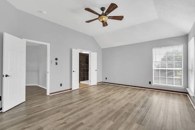 unfurnished bedroom with ceiling fan, light hardwood / wood-style floors, and vaulted ceiling