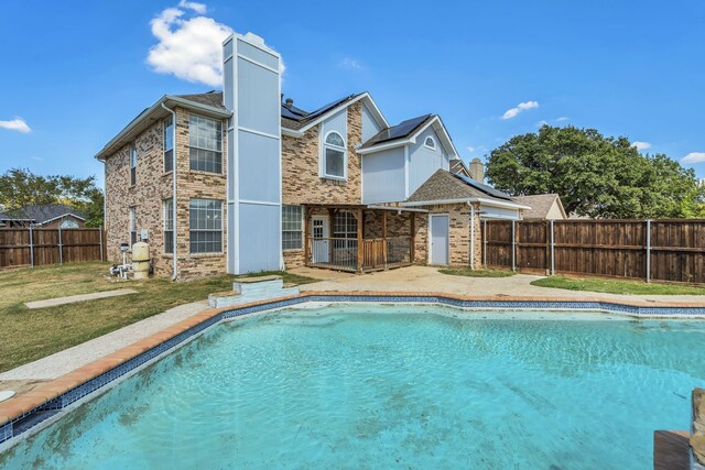 view of pool featuring a lawn and a patio