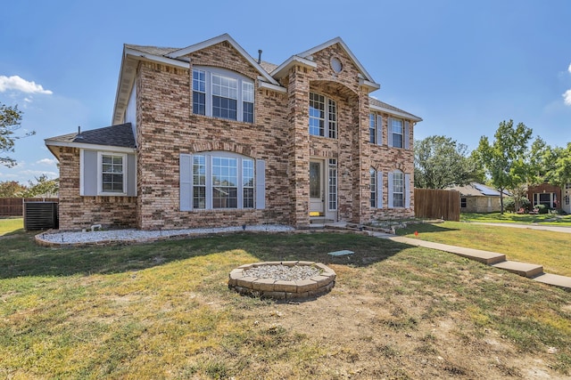 view of front of property featuring central AC and a front lawn