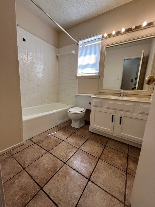 full bathroom with vanity, tiled shower / bath combo, a textured ceiling, tile patterned floors, and toilet