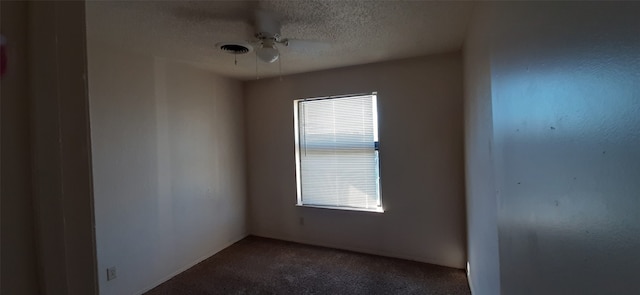 carpeted spare room featuring a textured ceiling