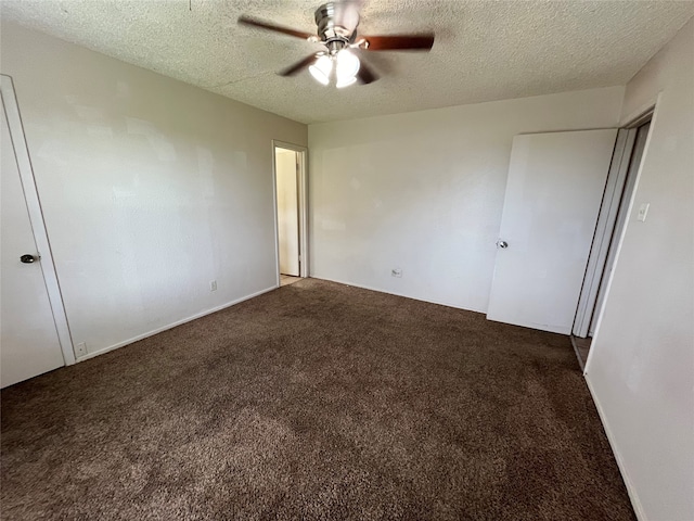 unfurnished bedroom with ceiling fan, a textured ceiling, and dark colored carpet