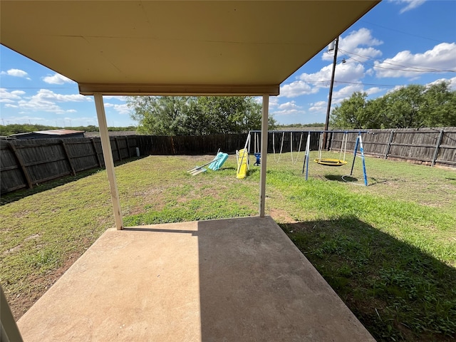 view of yard featuring a playground and a patio area