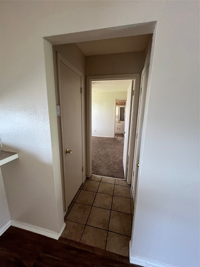 corridor with dark tile patterned floors