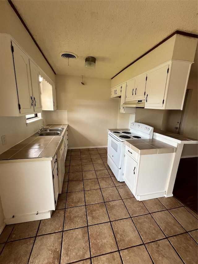 kitchen with a textured ceiling, white cabinetry, white electric range, and tile countertops