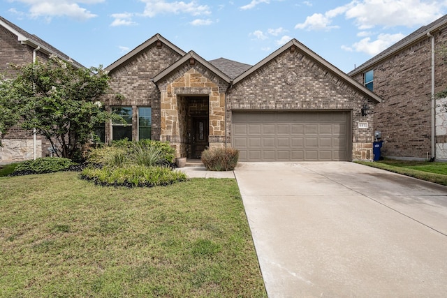 641 Fletcher Dr, Fate, TX 75087 - french country inspired facade with brick siding, a front yard, driveway, and a garage
