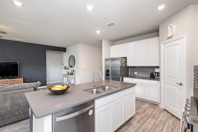 641 Fletcher Dr, Fate, TX 75087 - kitchen featuring a sink, open floor plan, light wood-style flooring, appliances with stainless steel finishes, and visible vents