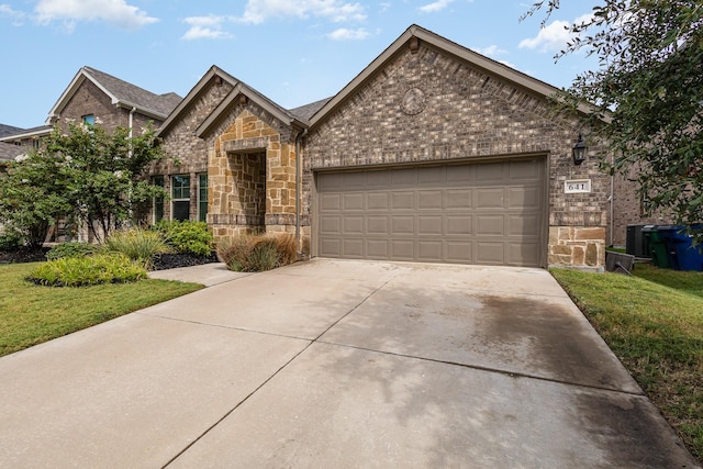641 Fletcher Dr, Fate, TX 75087 - view of front of house with a garage, driveway, stone siding, and brick siding