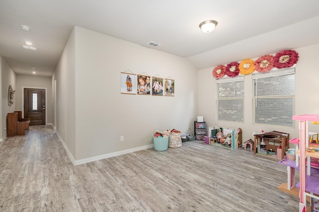 641 Fletcher Dr, Fate, TX 75087 - rec room with wood finished floors, visible vents, lofted ceiling, and baseboards