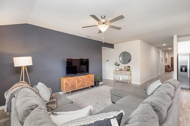 641 Fletcher Dr, Fate, TX 75087 - living area with vaulted ceiling, wood finished floors, ceiling fan, baseboards, and visible vents