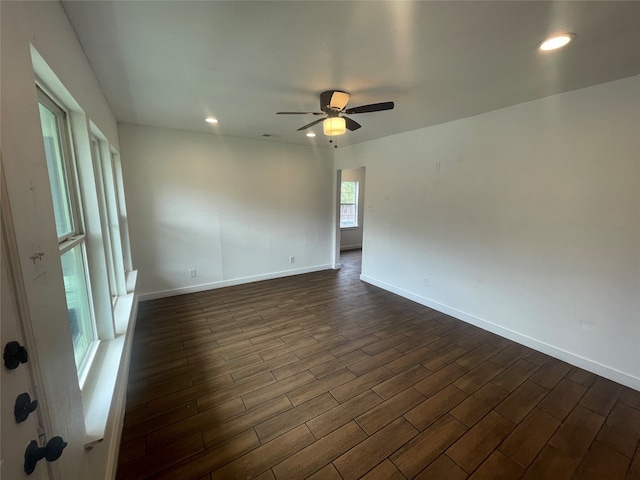 empty room featuring ceiling fan and dark hardwood / wood-style flooring