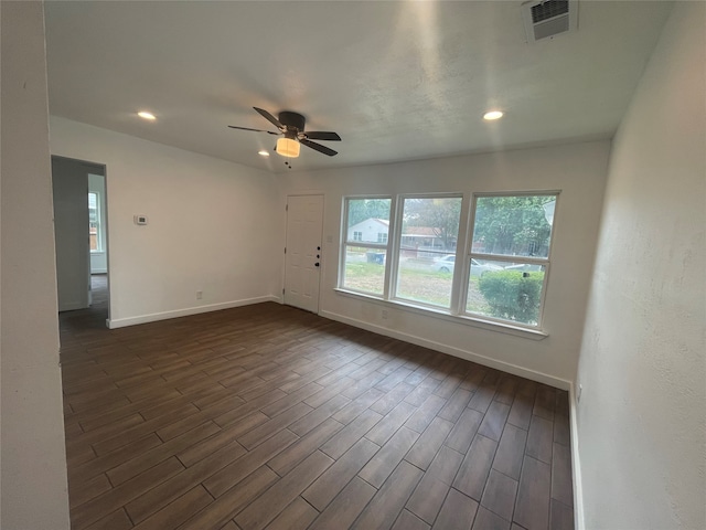 unfurnished room featuring ceiling fan and dark wood-type flooring