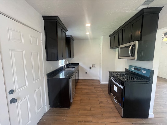 kitchen featuring stainless steel appliances, dark hardwood / wood-style floors, and sink