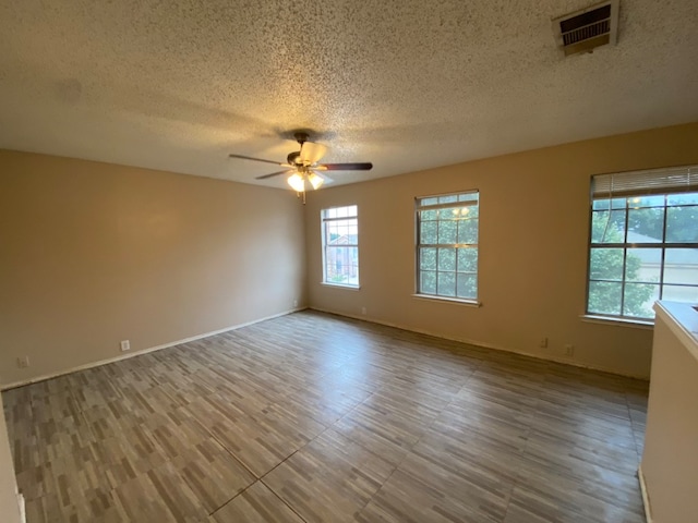 unfurnished room featuring a textured ceiling and ceiling fan