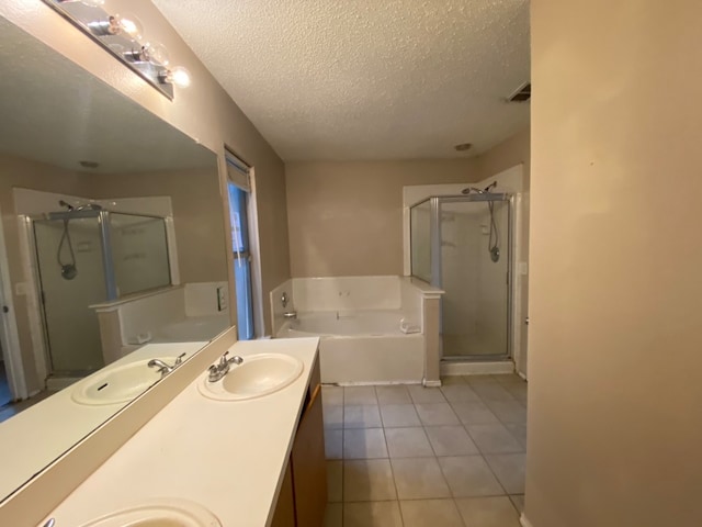 bathroom with vanity, separate shower and tub, a textured ceiling, and tile patterned floors