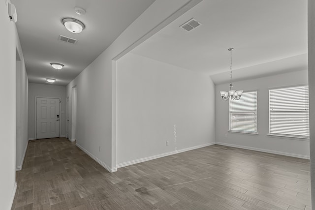 interior space featuring an inviting chandelier and light wood-type flooring